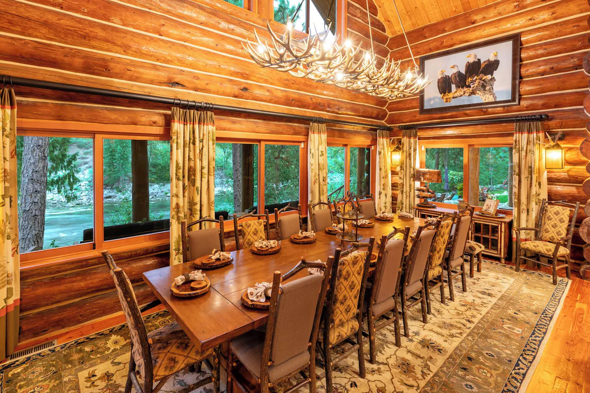 Long wooden dining table and chandelier in the Leavenworth great room